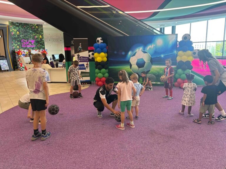 Football freestyler entertaining children with tricks at a birthday party show