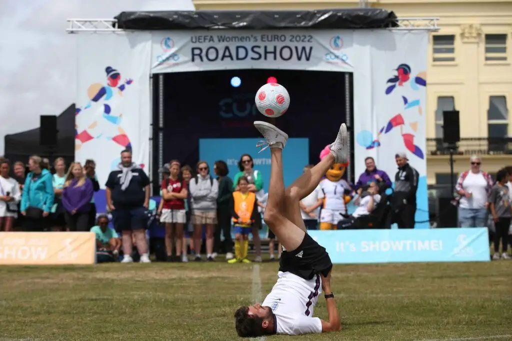 Football freestyler performing an acrobatic trick at the UEFA Women’s EURO 2022 Roadshow in front of a live audience